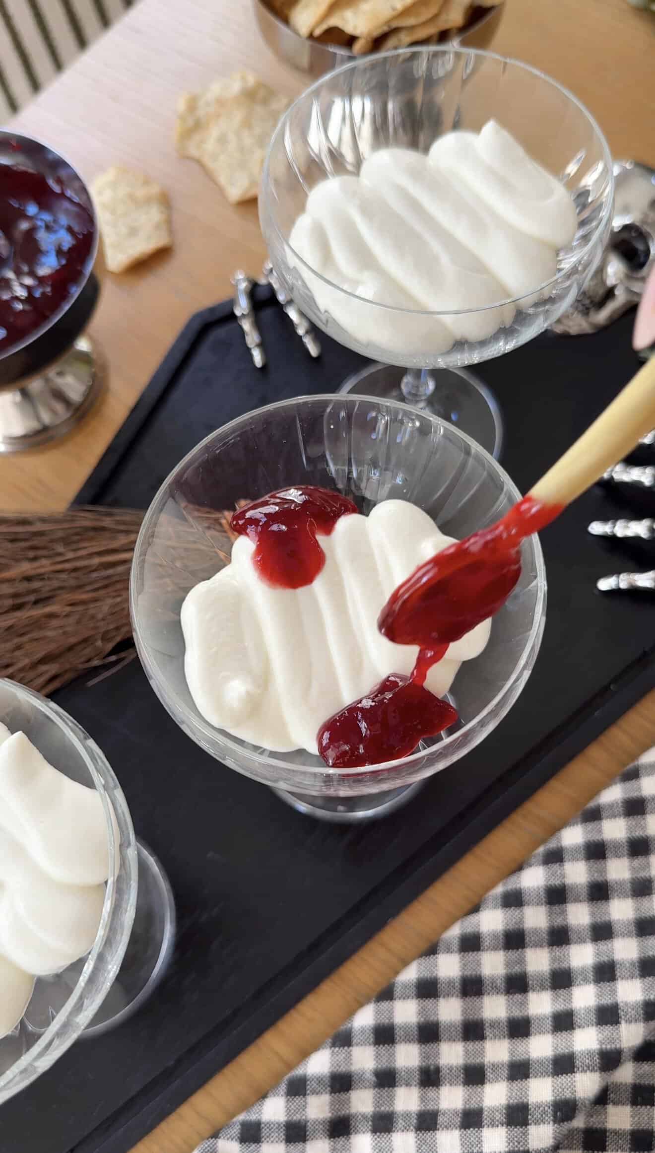 Creamy whipped ricotta and goat cheese with berry compote in glass bowls.