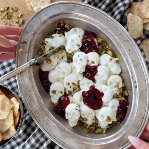 Creamy whipped ricotta and goat cheese with berry compote and pistachios.