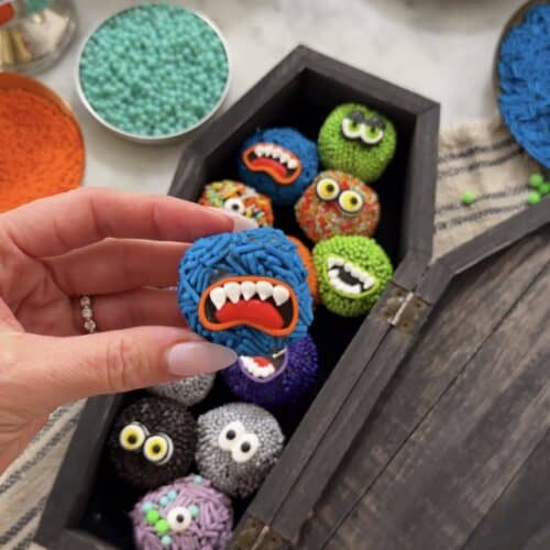 Colorful monster-themed brigadeiro candies for Halloween celebration.