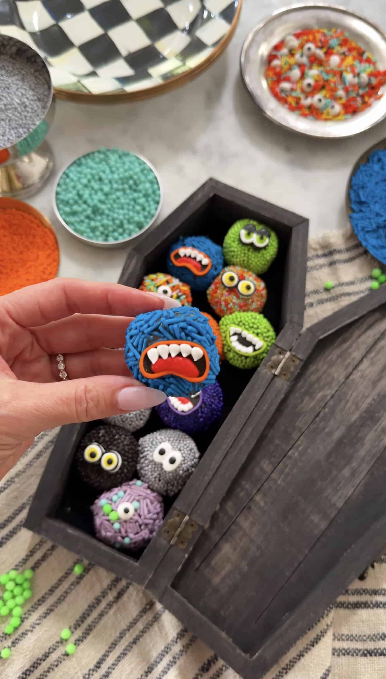 Colorful monster-themed brigadeiro candies for Halloween celebration.