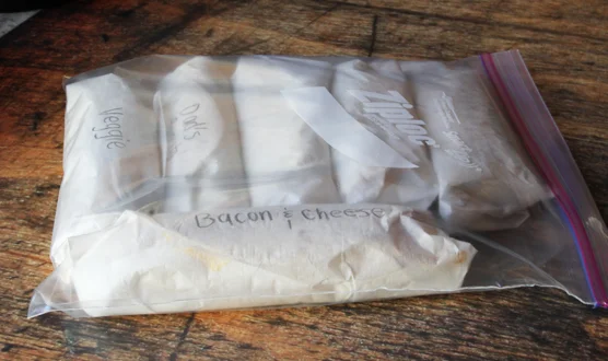 Now wrap and label your burritos. Use parchment paper to roll the burritos. This way you can put the wrapped burrito directly in the microwave in the morning. No plate, no mess. Store the burritos in a tight Ziploc bag. It is best to keep them …