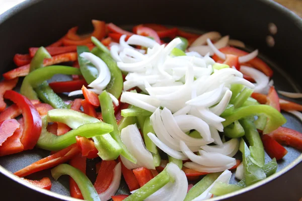 So first you need to saute your ingredients. I made 18 burritos in this tutorial so I used an entire white onion, and two large bell peppers. Which ever colors you like. I cooked everything with 1 1/2 tablespoons of olive oil and salt and pepper. Sa…