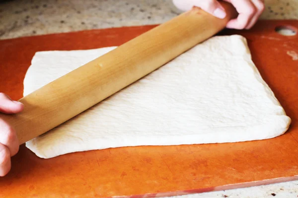 Roll in the opposite direction as well until you have a thin rectangle. About a half inch thick.