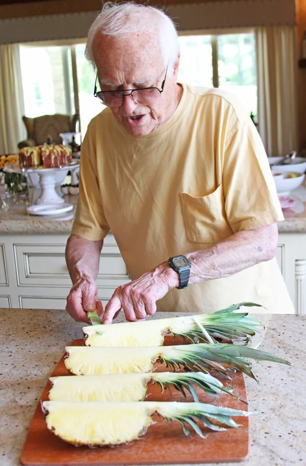 Ok, pay attention. Take your little carving knife and insert it into the pineapple but right below the hard core of the pineapple. This is the thick portion that you would normally cut off. DO NOT break through this core. Just insert your knife righ…